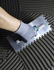 Tiling professional using a trowel